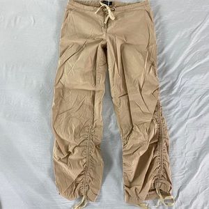 Bebe light tan pants with side rutching, side 6